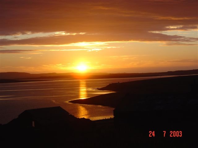 Sun setting behind Westray, from Eday