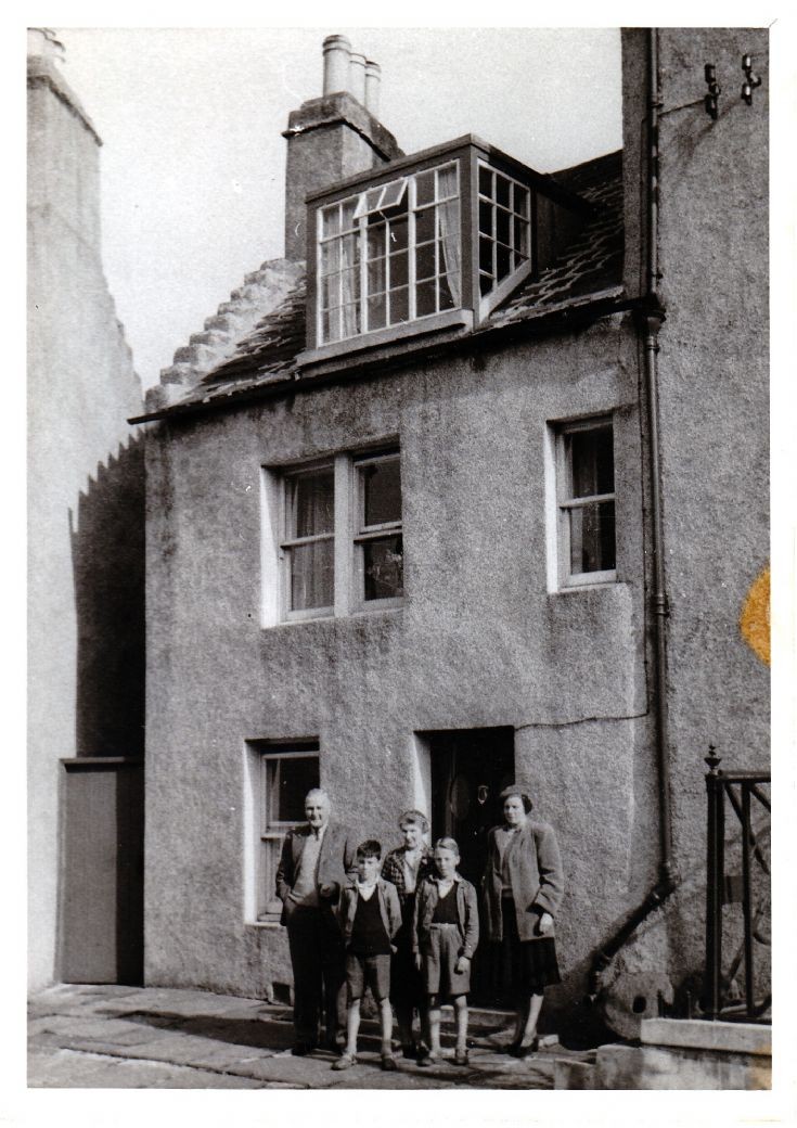 Willie and Sarah Costie in front of their house